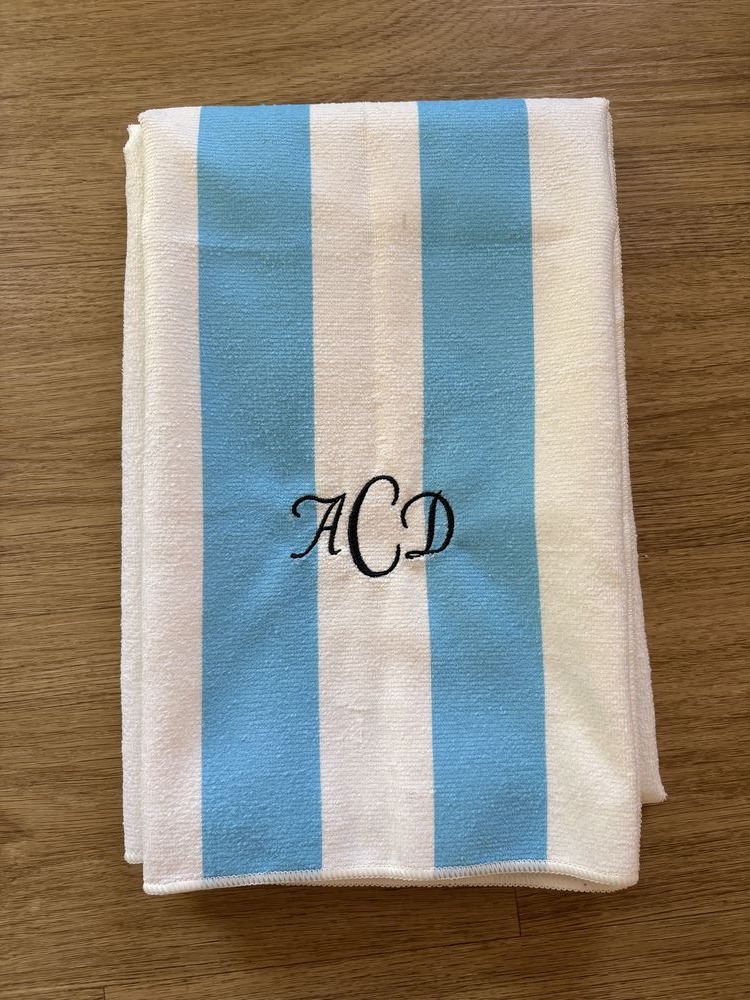 Striped cabana towel with a classic script monogram
