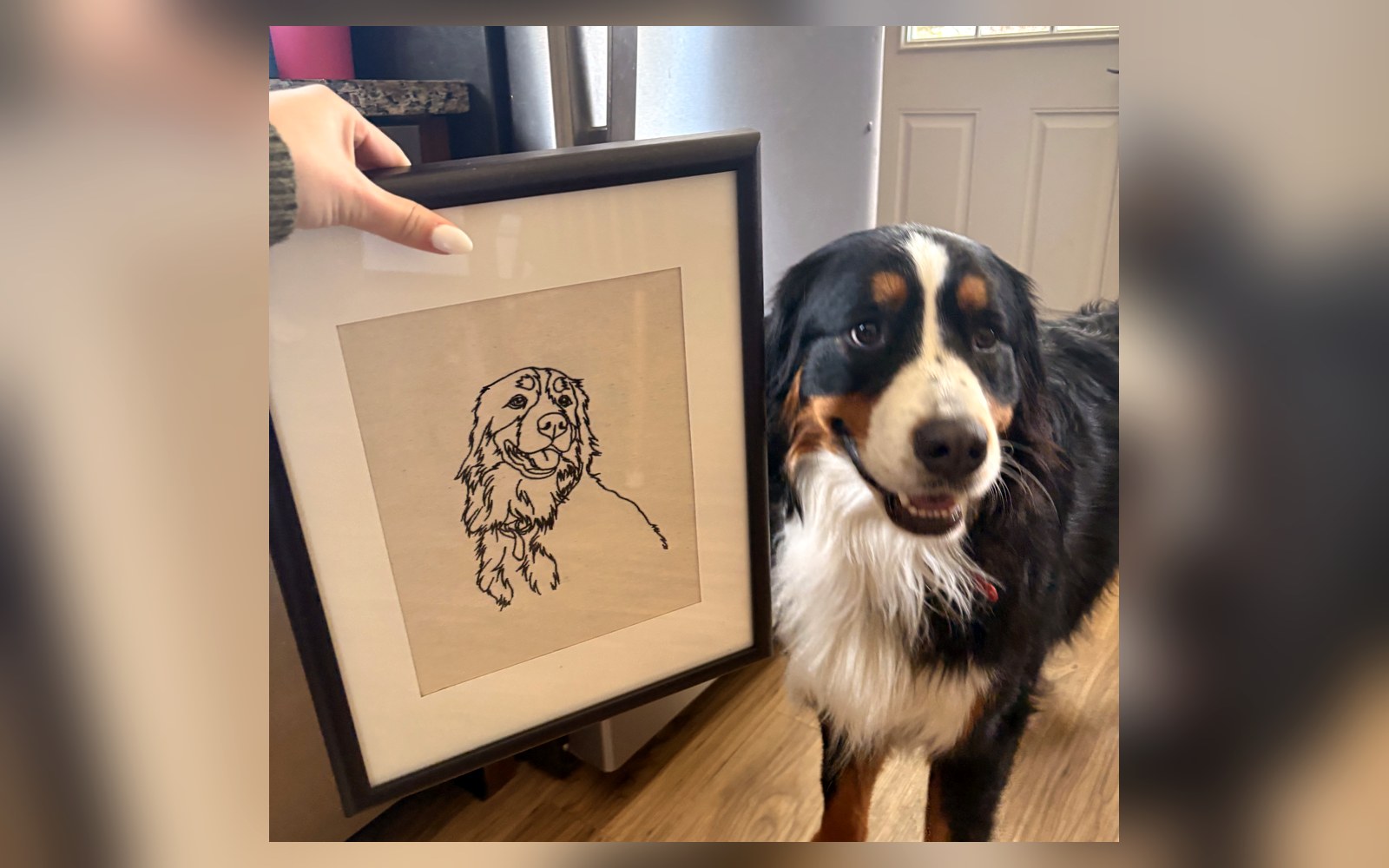Framed fine-line pet portrait beside the dog it depicts